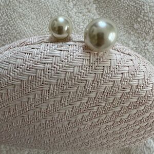 Chic Pink Woven Clutch with Pearl Accents